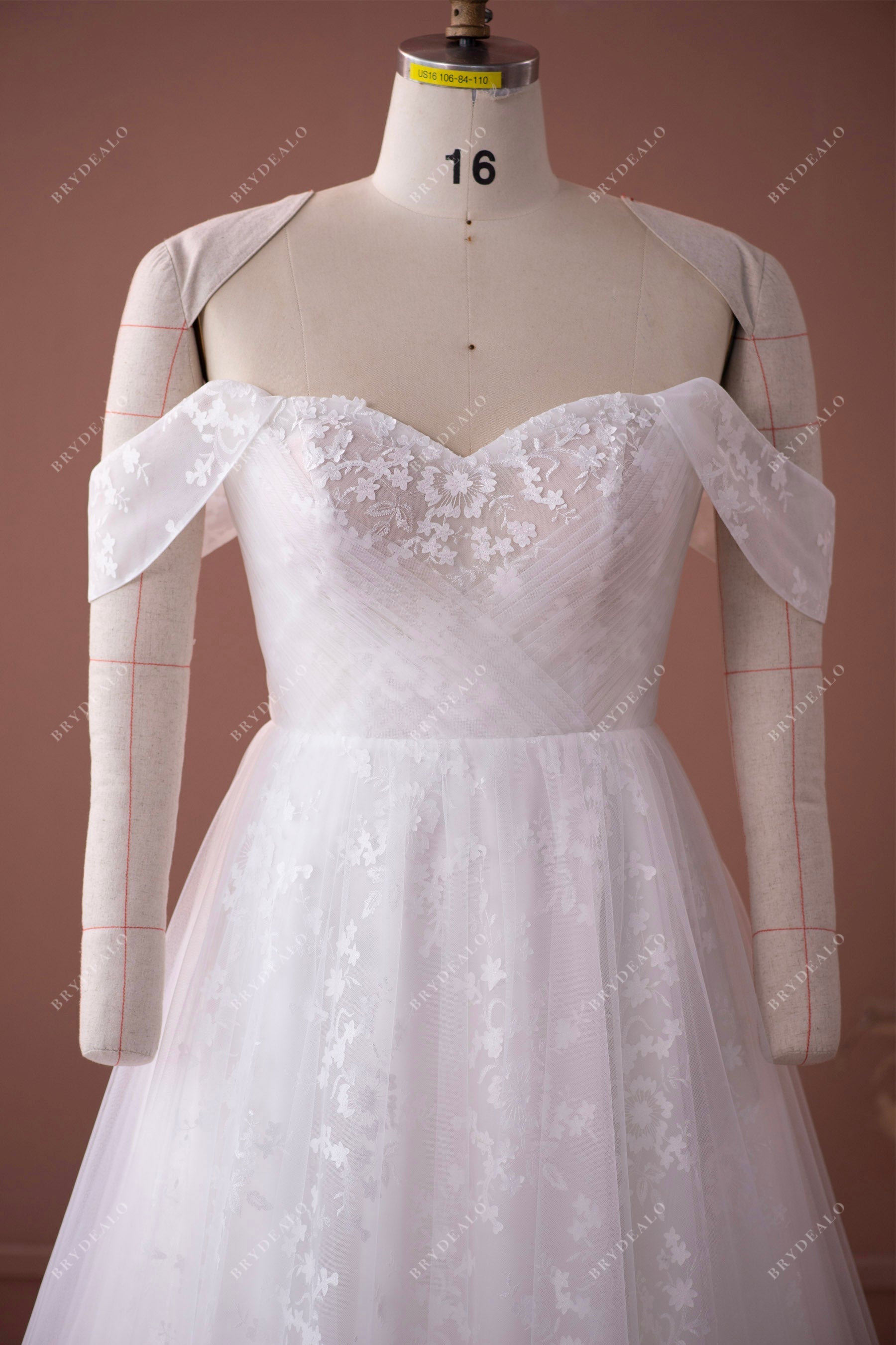 off shoulder crisscross tulle overlaid lace destination bridal gown