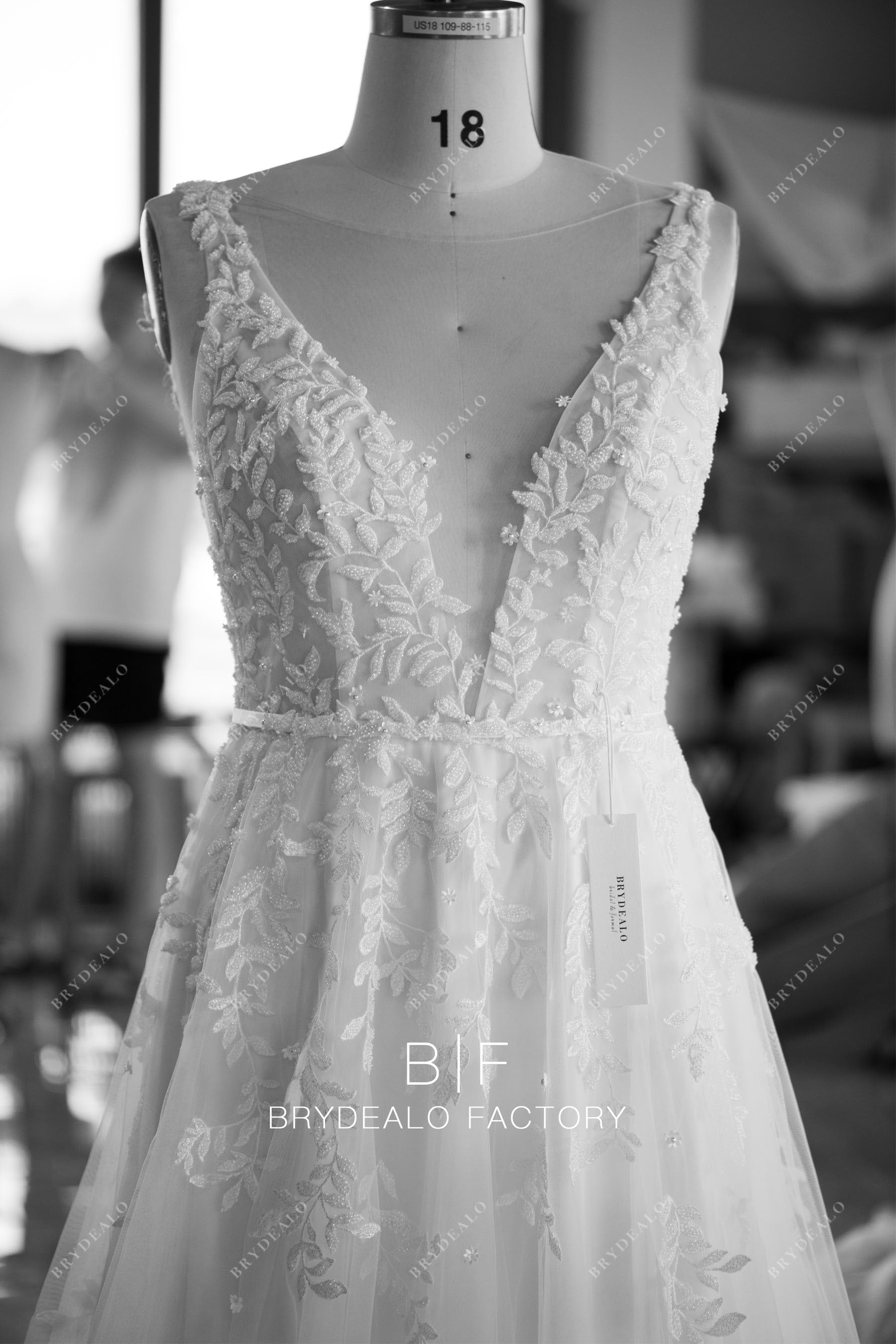 designer plunging beaded lace tulle wedding dress