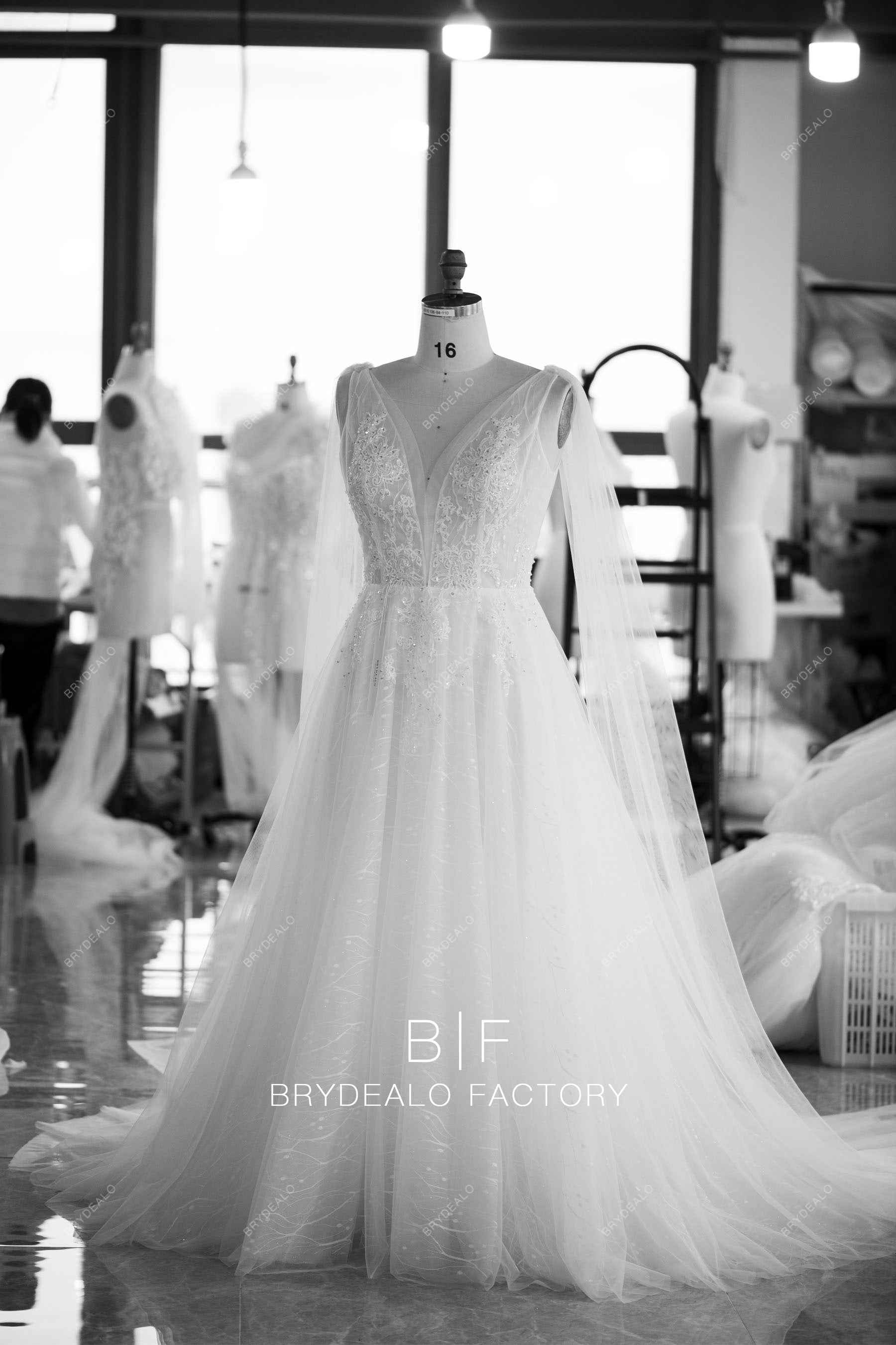 designer plunging lace shoulder streamer wedding dress